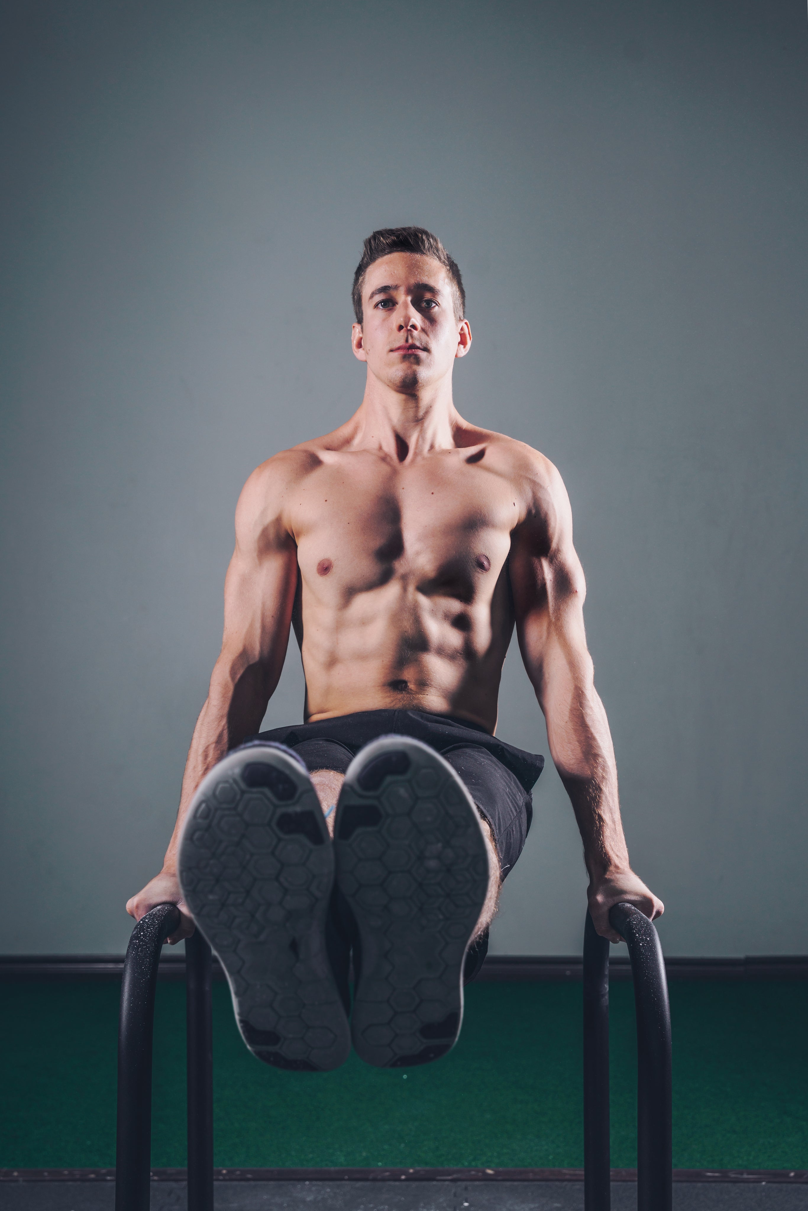 man lifing on bars exercising